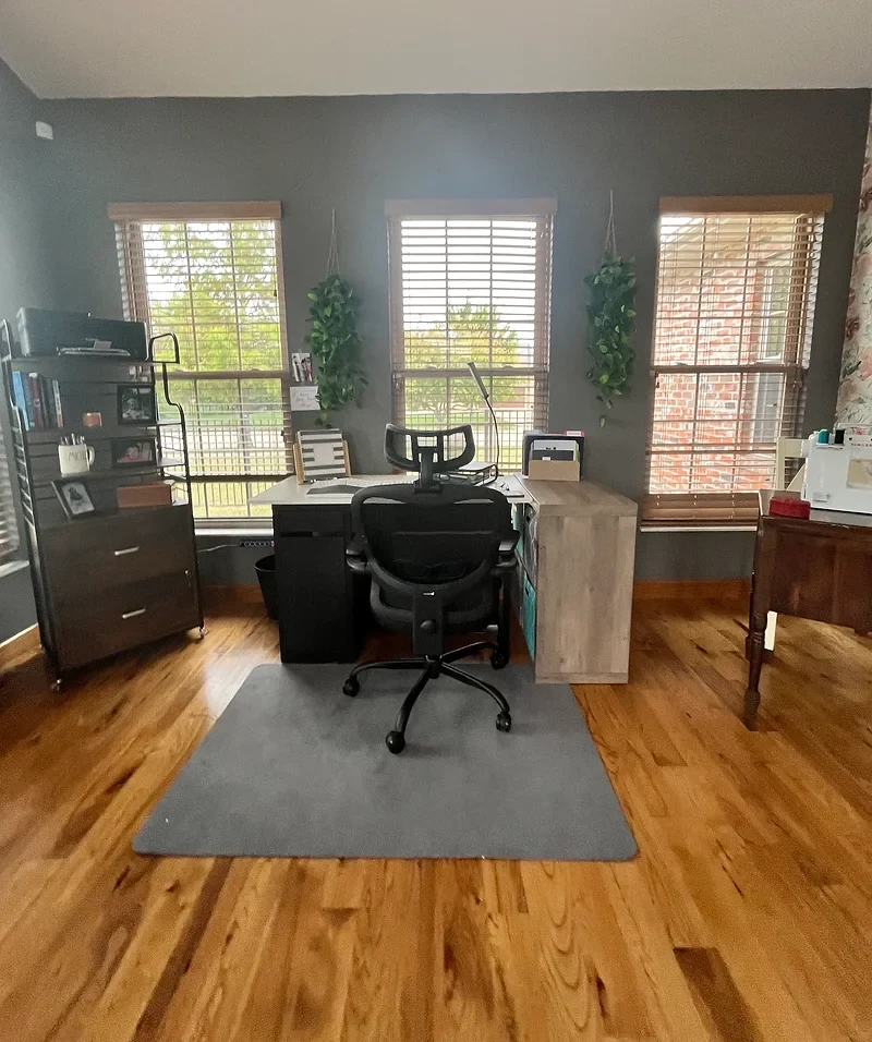 Home office with an organized desk, storage and windows