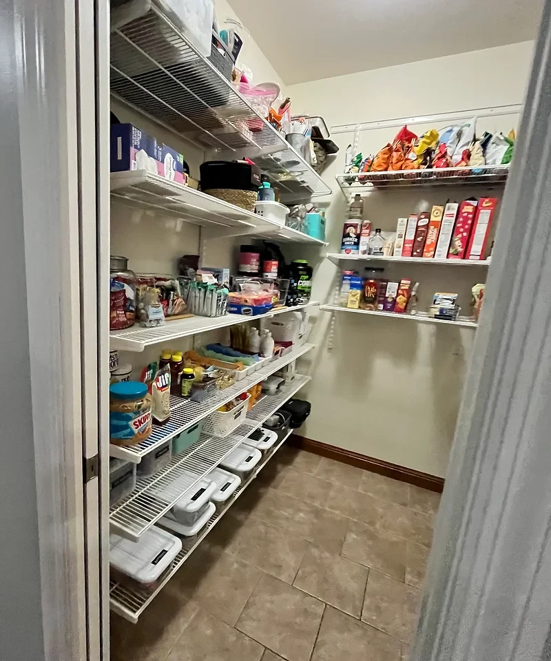 Pantry shelving with food grouped in baskets and clear containers, from a Just Right Organizing project